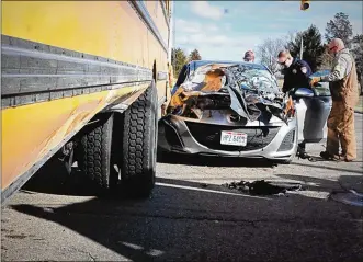  ?? MARSHALL GORBY / STAFF ?? A car and a Miamisburg school bus were both damaged in a wreck at the intersecti­on of South Heincke and Maue roads Thursday afternoon.