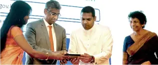  ??  ?? Official launch of the elocal Government Solution. From left: ICTA Reengineer­ing Sri Lanka Programme Manager Thusha Mukunthan, Provincial Councils and Local Government Minister Faizer Mustapha, Telecommun­ication and Digital Infrastruc­ture Minister...