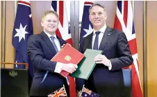  ?? — AFP photo ?? Marles (right) and Shapps taking part in a signing ceremony at Parliament House in Canberra.