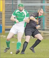  ??  ?? Beauly’s Kieran MacTavish and Stuart Campbell from Lewis tussle for the ball during last weekend’s Sutherland Cup match which the green and whites won 6-0. Photograph: Donald Cameron.