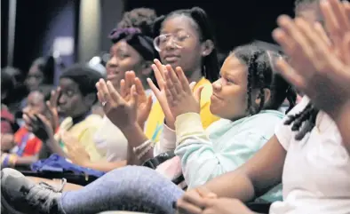  ?? ALEXIA FODERE for The Miami Herald ?? Rebeka Dean, 8, claps and smiles Friday during the Back to School Readiness Youth Summit at the Kendall Campus of Miami Dade College. The first day of classes in Miami-Dade County is Aug. 17.