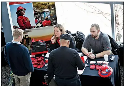  ?? AP ?? Visitors to a veterans’ job fair meet with recruiters at Heinz Field in Pittsburgh recently. U.S. job openings in January increased to 7.6 million.