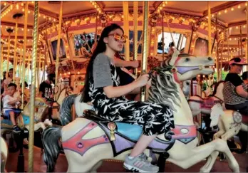  ?? LIANG SHENGJIAN / FOR CHINA DAILY ?? Visitors enjoy rides at Hong Kong Disneyland. The Hong Kong Economic Times said that 60 percent of mainland individual visitors choose Macao and that Hong Kong is no longer their top choice.