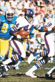  ?? Richard Stagg / Getty Images ?? Denver Broncos running back Floyd Little heads upfield on a run against the San Diego Chagers in a December 1973 game at San Diego Stadium in San Diego, Calif.