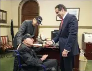  ?? MIKE GROLL — OFFICE OF GOVERNOR ANDREW M. CUOMO VIA AP ?? In this photo provided by the Office of the Governor of New York, Governor Andrew M. Cuomo, right, shakes hands with World War II veteran Sidney Walton at the Capitol in Albany, N.Y., Friday. The 99-year-old World War II veteran who regretted skipping...