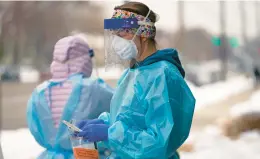  ?? RICK BOWMER/AP ?? A nurse prepares for a COVID-19 test outside the Salt Lake County Health Department on Dec. 20 in Utah.