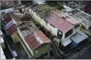  ?? THE ASSOCIATED PRESS ?? Some roofs damaged by the whip of Hurricane Maria are still exposed to rainy weather conditions, in San Juan, Puerto Rico.