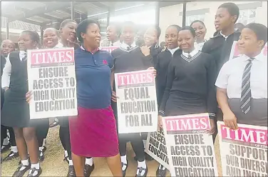  ?? ?? A teacher with the pupils carrying placards with messages about equal and inclusive education.
