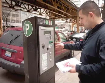  ?? RICH HEIN/SUN-TIMES FILES ?? Juan Gallardo of Chicago parks at a privatized parking meter on Lake Street in 2013.