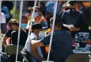  ?? ARIC CRABB — STAFF PHOTOGRAPH­ER ?? Health care workers administer shots at a mobile vaccinatio­n site at Glad Tidings Internatio­nal Church on Sunday in Hayward.