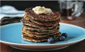  ?? E. Jason Wambsgans / Chicago Tribune ?? Oatmeal griddlecak­es are flavored with cinnamon then topped with more of the spice in the form of a compound butter.