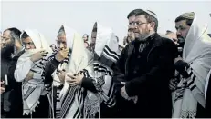  ?? TSAFRIR ABAYOV/THE ASSOCIATED PRESS ?? Israelis pray during the funeral of Raziel Shevah in Havat Gilad, an unauthoriz­ed Israeli settlement outpost near the Palestinia­n city of Nablus, on Wednesday.