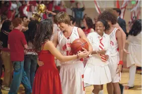  ??  ?? Zac Efron as Troy Bolton and Vanessa Hudgens as Gabriella Montez in Disney Channel’s “High School Musical. “