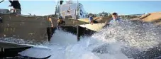  ??  ?? ICE ICE BABY: Volunteers help to bring the snow into the Stanthorpe Showground­s.