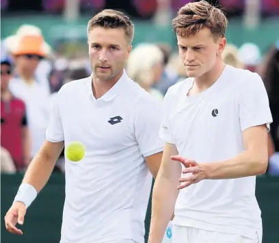  ?? Steven Paston ?? ●●Scott Clayton and Stockport’s Liam Broady (left) were forced to retire after Clayton suffered an injury during their second round doubles contest at Wimbledon