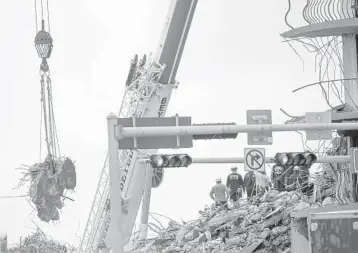  ?? SENTINEL
CHRIS DAY/SOUTH FLORIDA SUN ?? Search and rescue teams look for possible survivors and to recover remains on Wednesday at the site of the 12-story oceanfront Champlain Towers South Condo, which partially collapsed about 2 a.m. on June 24 in Surfside.