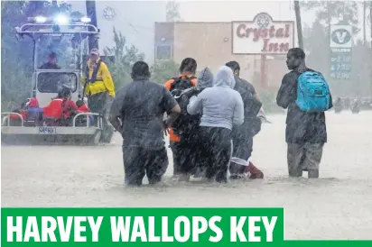  ?? LEE CELANO, THE (LAFAYETTE, LA.) DAILY ADVERTISER, VIA USA TODAY NETWORK ?? Residents seek higher ground in the Tidwell Lakes area of Houston, where 30 inches of rain has fallen in some places.