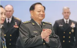  ?? AP ?? Zhang Youxia, vice-chairman of the Central Military Commission, applauds as Steve Koehler, right, commander of the U.S. Pacific Fleet, and Alexander Moiseyev, second from left, Russia’s chief of navy, look on during the Western Pacific Navy Symposium in Qingdao, China, on Monday.