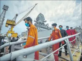  ?? PRATIK CHORGE/HT PHOTO ?? Crew members of ONGC's Barge P305 who were stranded off the Mumbai shore come out of INS Kochi on Wednesday after they were rescued by the Indian Navy.