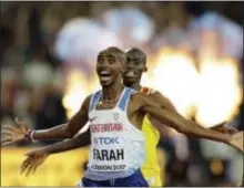  ?? TIM IRELAND — THE ASSOCIATED PRESS ?? Britain’s Mo Farah, left, celebrates after winning men’s 10,000 meters final on Friday. the