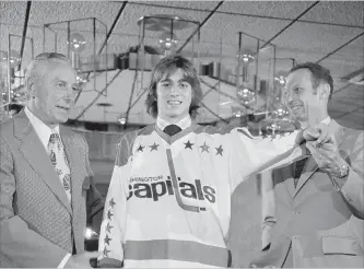  ?? CANADIAN PRESS FILE PHOTO ?? No. 1 draft pick Greg Joly tries on a jersey after he signed a deal with the Washington Capitals in Landover, Md., on May 28, 1974. The expansion ’74-75 Capitals remain statistica­lly the worst team in NHL history.