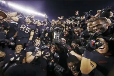  ?? MATT ROURKE - THE ASSOCIATED PRESS ?? Army players celebrate with the Commander in Chief’s trophy following a 17-10 victory over Navy in an NCAA college football game, Saturday, Dec. 8, 2018, in Philadelph­ia. Army won 17 -10.