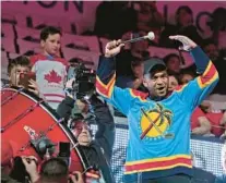  ?? WILFREDO LEE/AP ?? Miami Dolphins quarterbac­k Tua Tagovailoa pumps up the crowd before the start of Thursday night’s game between the Florida Panthers and the Dallas Stars in Sunrise.