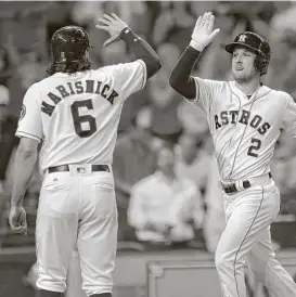  ?? Karen Warren / Houston Chronicle ?? Alex Bregman, right, puts the Astros’ win on ice Wednesday night with a threerun homer in the eighth inning that drew the appreciati­on of Jake Marisnick.