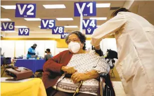  ?? K.C. ALFRED U-T ?? Soledad Bernal gets a COVID-19 vaccine at the Sharp South Bay Super Station on Feb. 11 in Chula Vista. Some South Bay cities have much lower vaccinatio­n rates than wealthier cities.