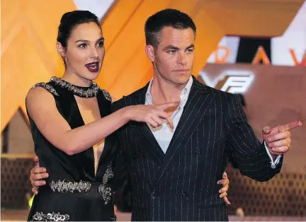  ?? REBECCA BLACKWELL/THE ASSOCIATED PRESS ?? Actor Chris Pine, right, has nothing but praise for his Wonder Woman co-star Gal Gadot, left. “That softness and beauty and strength to me is the critical combinatio­n, and Gal has it in spades,” Pine says.