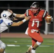  ?? GENE WALSH — DIGITAL FIRST MEDIA ?? Upper Dublin quarterbac­k Mike Slivka tries to elude Quakertown’s Max Russell Friday night.