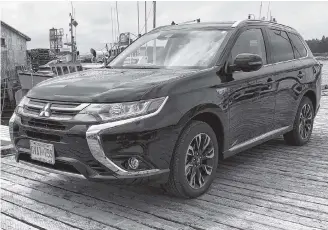  ?? Richard Russell ?? The 2018 Mitsubishi Outlander PHEV SE is powered by its 2.0-litre, four- cylinder engine and two electric motors.