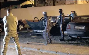  ?? PICTURE: EMILIO MORENATTI/AP/AFRICAN NEWS AGENCY (ANA) ?? French police search a car in Carcassonn­e after a gunman hijacked a vehicle, killed four people, including a police officer, and took hostages at a supermarke­t before being shot dead.