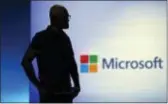  ?? ELAINE THOMPSON — THE ASSOCIATED PRESS FILE ?? Microsoft CEO Satya Nadella looks on during a video as he delivers the keynote address at Build, the company’s annual conference for software developers in Seattle. Microsoft is threatenin­g to overtake Apple as the world’s most valuable publicly traded company.