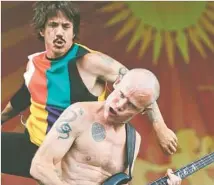  ?? David Grunfeld The Times-Picayune ?? CHILI PEPPERS’ Anthony Kiedis, left, and Flea groove at Jazz Fest in New Orleans in April. Their latest album drops June 17.