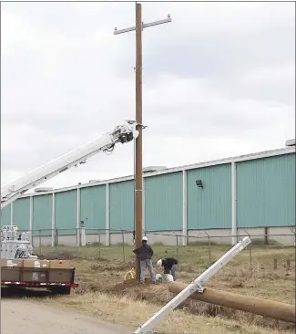  ?? Submitted Photo ?? Crews with Entergy have worked over the past week to replace utility poles on the former Sanyo property, which has been purchased by Olymbec USA. The crews began work on the property’s north end with plans to replace all the poles on the property.