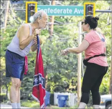  ?? JOHN SPINK / JSPINK@AJC. COM ?? Confederat­e Flag runner Alan Keck (left) debates Grant Park resident Katie Kurumada about the petition to change the name of Confederat­e Avenue on Tuesday on Boulevard.