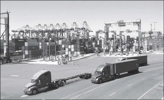  ?? AP ?? Photo shows trucks along a loading dock at the Port of Long Beach in Long Beach, California.