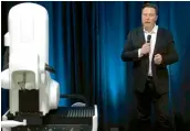  ?? AFP ?? This video grab made from the online Neuralink livestream shows Elon Musk standing next to the surgical robot during his Neuralink presentati­on. —