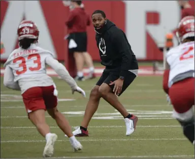  ?? (NWA Democrat-Gazette/Andy Shupe) ?? Kenny Guiton, Arkansas’ new wide receivers coach, leads players during Tuesday’s practice, the opening workout for the Razorbacks’ spring drills. See more photos at arkansason­line.com/310footbal­l.