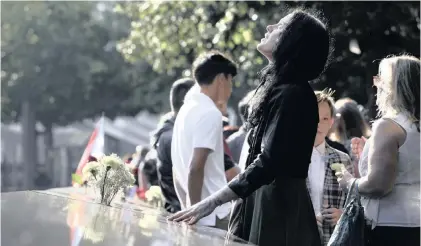  ?? | AP ?? A WOMAN stands next to the north pool before a ceremony marking the 18th anniversar­y of the attacks of September 11, 2001 at the National September 11 Memorial in New York, yesterday.