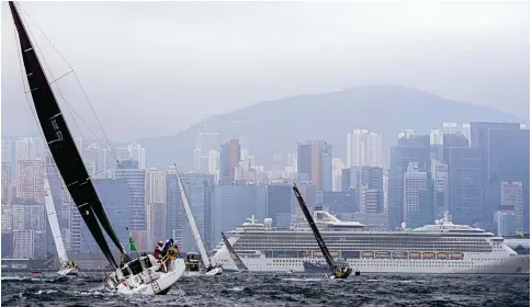  ?? Photo: Elson Li ?? Yachts start the 2024 Rolex China Sea Race at Victoria Harbour, with the Serenade of the Seas cruise ship in the background on its first visit to the city.