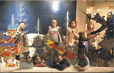  ?? Photo by Teresa Graham-Sullivan ?? CAFTA students, from left, set up their art bomb in the Libby’s window: standing, from left, Nick, 9; Tariana, 9; Daniela, 9; Alixis, 9; front row, Yarelie, 5; Elizabeth, 10; Zalisha, 7, and Sophia, 6.
