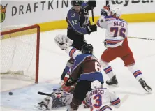  ?? Joe Mahoney / Associated Press ?? Colorado’s Erik Johnson (6) scores on New York goalie Henrik Luindqvist as Avalanche left wing Gabriel Landeskog (92) holds off Rangers defenseman Brady Skjei (76).