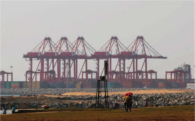  ??  ?? COLOMBO: In this March 15, 2016 file photo, a Sri Lankan couple walk on the Galle Face green as the China Port City project is seen behind in Colombo, Sri Lanka. —AP