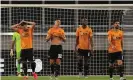  ??  ?? Wolves players look dejected after Lucas Ocampos’s 88th-minute goal for Sevilla in the MSV Arena. Photograph: James Williamson - AMA/Getty Images