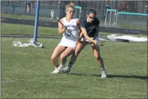  ?? STAFF PHOTOS BY MICHAEL REID ?? La Plata’s Morgan Leonard, right, fends off Leonardtow­n defender Haley O’Reagan in Monday’s SMAC championsh­ip game. Leonard scored all three La Plata goals in a 22-3 loss.