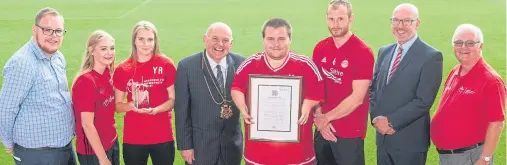  ??  ?? GOALDEN ACHIEVEMEN­T: Lord Provost Barney Crockett and Trust members proudly show off the Queen’s Award