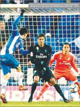  ?? AFPPIX ?? Espanyol’s Gerard Moreno (left) shoots to score against Real Madrid during their La Liga match at the RCDE Stadium yesterday. –