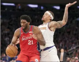  ?? SETH WENIG — THE ASSOCIATED PRESS ?? Philadelph­ia 76ers’ Joel Embiid, left, and New York Knicks’ Michael Beasley battle for position during the second half of an NBA basketball game, Monday in New York. The 76ers defeated the Knicks 105-98.